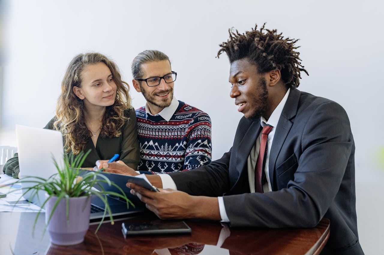 A diverse group of professionals collaborating in an office meeting, showcasing teamwork and partnership.